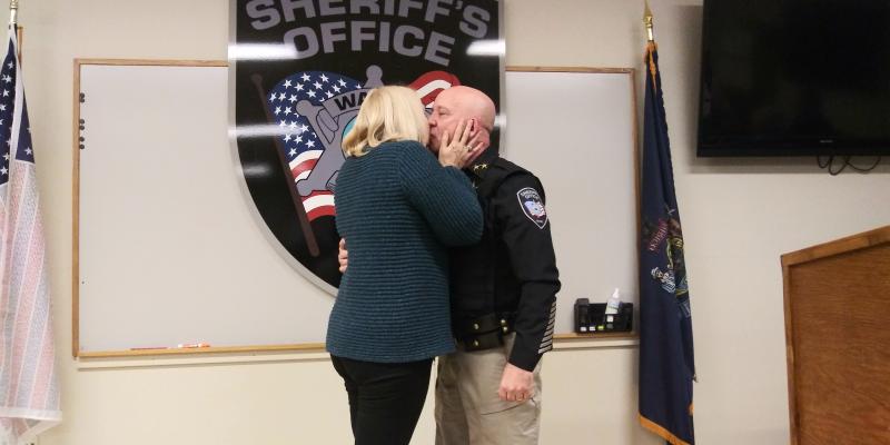 Sheriff Trundy hugs wife Lorraine after she pins him with his new badge. (photo by Erica Thoms)