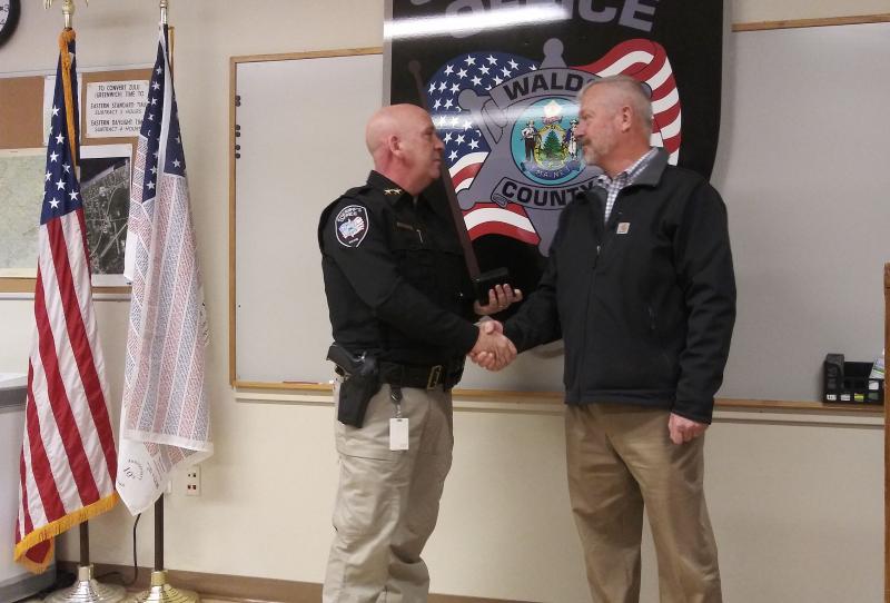 Sheriff Trundy presenting outgoing, former Sheriff Jeffrey Trafton with a retired badge as a token of appreciation from the Sheriff’s Office. (photo by Erica Thoms)