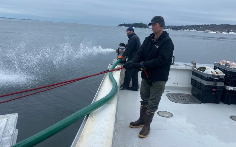 Pumping and towing the Flying Pigs from Adam Scott’s lobster boat. (Photo courtesy Camden Harbor Master)