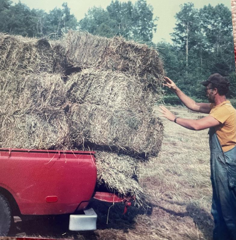 Wally O’Brien loads hay into the back of the old Toyota to feed the cow and pony for the coming winter. (Photo courtesy of Diane O’Brien) Hay