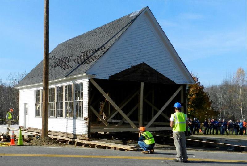 Moving Day. The town drags the old building to its new home on the far side of Main Street. (Photo courtesy of The Lincolnville Library) Moving