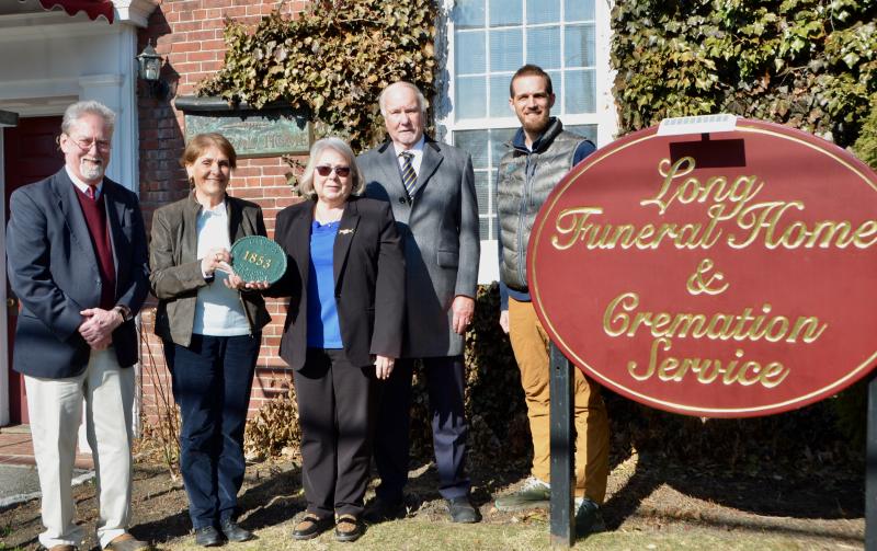 On March 23, The Camden Historic Resources Committee presents an historic landmark plaque to the Long Funeral Home to place on the outside of the old school house, built in 1853. From left to right: John Laite, Pat Skaling, Julie Clement, John Long and Will Addis, Chair of the Historic Resources Committee. (Photo by Lynda Clancy)