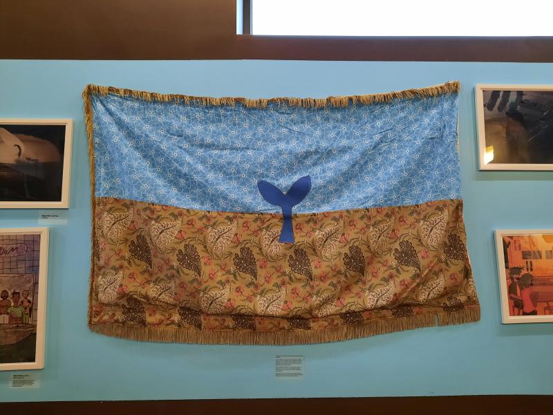 A flag created by high school students during a workshop led by fiber artist Steven Frost hangs at Rock City Café during Pride Month. (Photo courtesy OUT Maine)