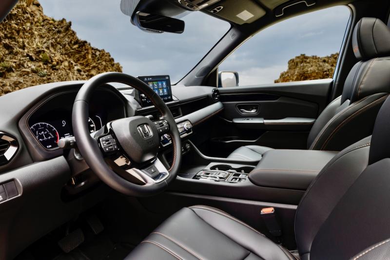 The Trailsport Pilot’s leather upholstery is stitched and logo’ed in red. Note the absence of a gearshift lever—instead, there are buttons in the center console that must be pushed, to select Drive or Park, or pulled, for Reverse. The two toggle switches in the console set the drive mode (Normal, Econ, Snow, Sport, Tow, Trail, Sand) and the e-brake.