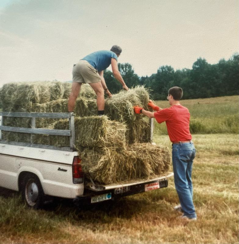 Overloading the old truck with hay bales. (Photo by Diane O’Brien) Haying