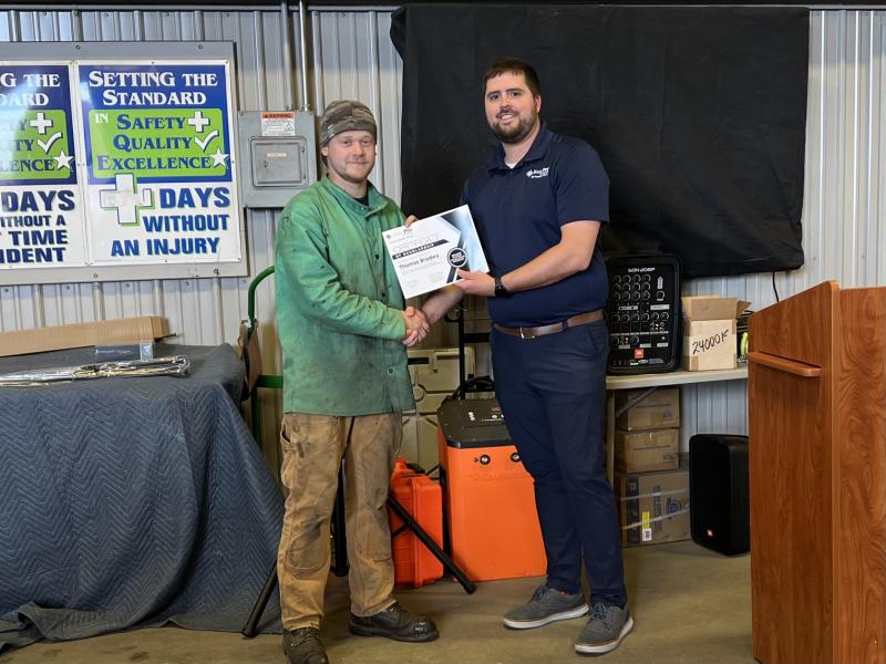 Thomas Bradley receives scholarship certificate from Thomas Kennedy II. (Photo courtesy Steel-Pro Incorporated)