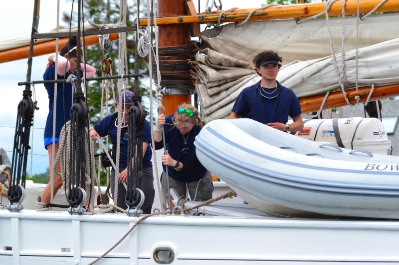 Crew members prepare for their voyage. Landen Parks, second from right, is the great-great-granddaughter of a former Bowdoin crew member who sailed in 1929. FRITZ FREUDENBERGER/Boothbay Register