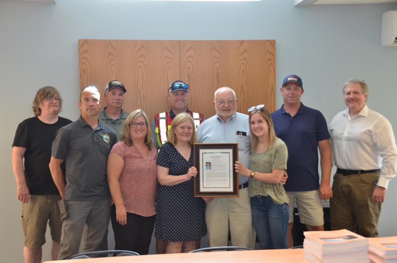 Allen Mitchell is surrounded by fellow firefighters and family. From left: Charlie Pearson, Brandon Allen, Todd Philbrook, Fire Chief Jason Peasley, Daughter Jill Mitchell, Wife Marge Mitchell, Granddaughter Alison Saucier, John Wickenden and Bill Lane. (Photo by Lynda Clancy)