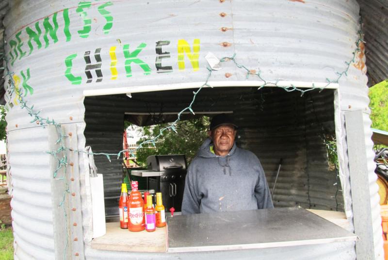 Dennis stands in the window of the corrugated hut that Beth’s had built for his cooking. Photo by Kay Stephens