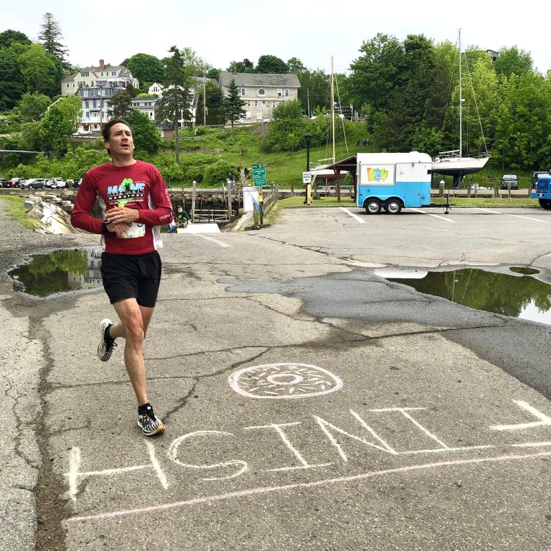 Scott Layton crosses the finish line as overall first place winner. (Photo courtesy Rockport Public Library)