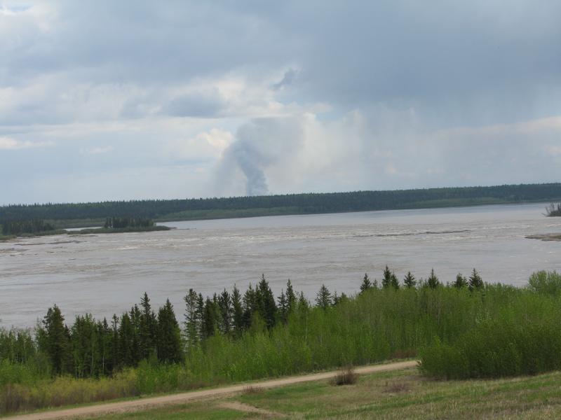 A column of smoke rises from a distant wildfire near Fort Smith, Northwest Territories. Courtesy of Jeff Wells. #bird-column, #jeff-and-allison-wells, #maine, #birds, #boothbay register, #boreal forest, #canadian wildfires