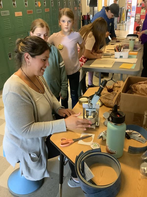 Tina Moro (UE science teacher) helped students create buttons with a button machine supplied by the Farnsworth Art Museum. (Photo courtesy Brenda Thomas)
popupcycler.jpg – Rockland artist Kim Bernard brought her Pop UpCylcer and showed students how to turn #2 plastics into art.
Books in Every Nook.jpg – Jenny West (Title 1 teacher) is seen at most school events making sure that everyone gets free books through Books in Every Nook.
Mr Drew.jpg – Mr. Drew brought a variety of animals including two snakes, some lizards, a scorpion, Madagascar hissing cockroaches, a tarantula, a turtle, and a 50-pound tortoise named Tank.