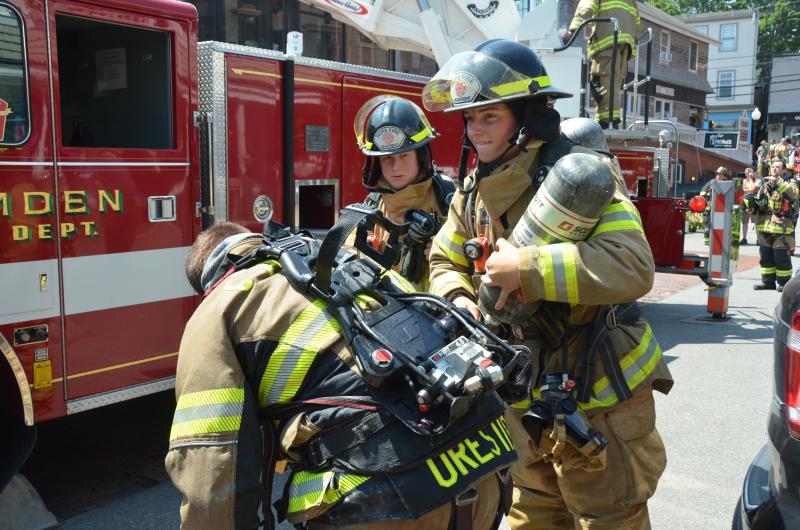 Changing air tanks on firefighters entering the smoke-filled building. (Photo by Lynda Clancy)