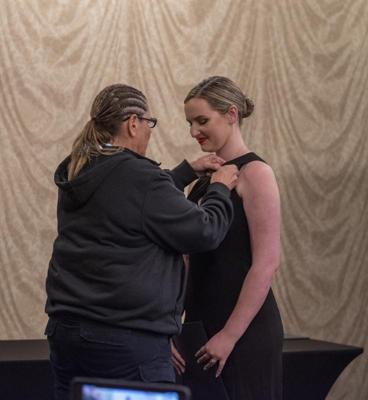 Paige Smith is pinned by EMS educator and paramedic Amy Drinkwater, after Smith earned her paramedic license. (Photo courtesy Paige Smith)