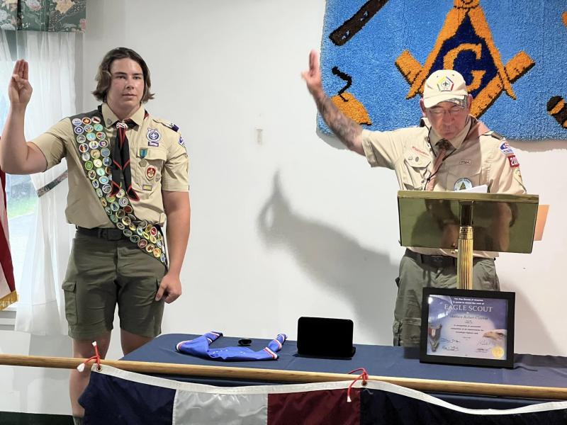 Scoutmaster Ed Weber, an Eagle Scout, administers the Eagle Scout Charge to Matthew Clayton. (Photo courtesy Chuck Mahaleris)