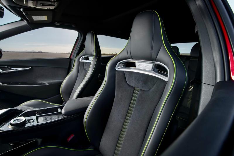 The EV6 GT’s deeply bolstered sport seats are covered with “vegan suede” and trimmed with green piping. Other premium touches include neon accents and ambient lighting. The rear seats are notably roomy (for two) and have adjustable backrests, but reclining them eats into the cargo bay under the liftback. Folding the rear seatbacks down, on the other hand, creates significant space. This is a utility vehicle, too.