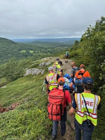It is a slow and careful process transporting an injured patient down from the top of a mountain, and takes many strong hands. (Photo courtesy Camden Fire Dept.)