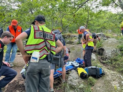 First responders tend to the injured woman, stabilizing and then transporting her down the trail from the top of Bald Mountain in Camden. (Photo courtesy Camden Fire Dept.)