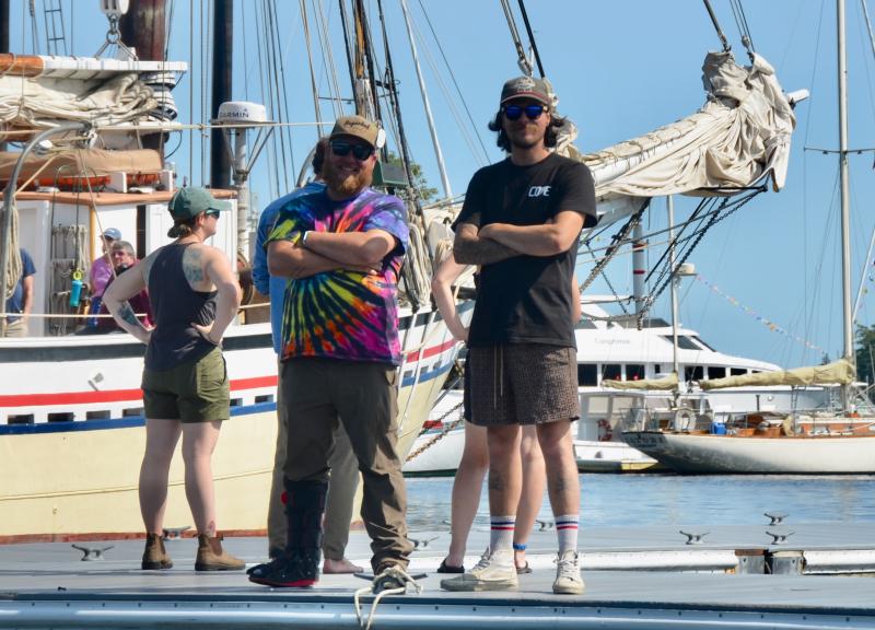 Camden staff members Josh Johnson and Adam Jipson helps out as the schooners move in Friday afternoon. (Photo by Lynda Clancy)