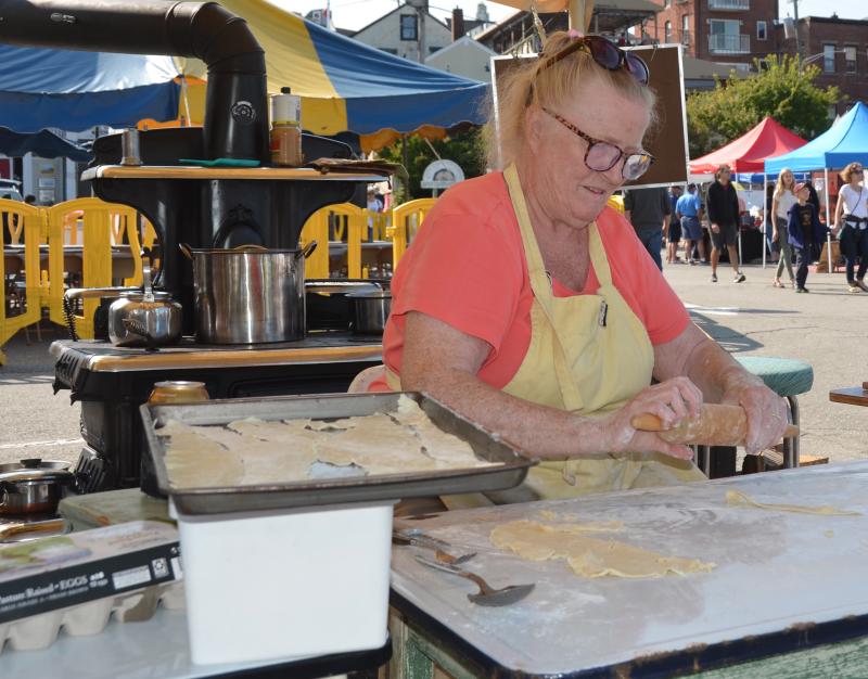 Bridget Qualey again loaded her Clarion kitchen wood stove on trailer, along with an icebox reminiscent of the 1930s, and displayed for two days how meals are prepared on schooners, and in old Maine kitchens, in general. (Photo by Lynda Clancy)