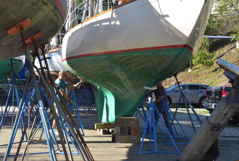 Each boat needs securing on its stands, so the hulls are snug and supported.