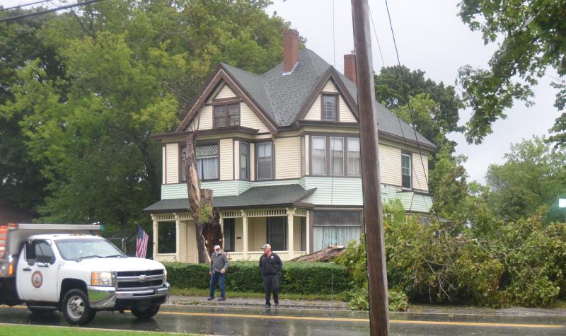 In Rockland, Fire Chief Chris Whytock confers with a homeowner of property where a large tree came down, and took down wires, as well.