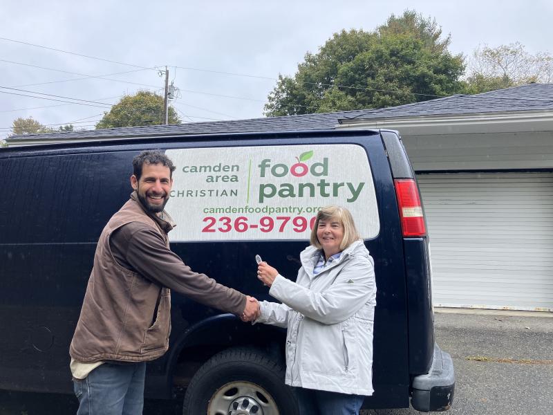 Aaron Englander, MCHT associate director of Farm Preserves, accepts the van keys from Debra Milliken, Board President of Camden Area Christian Food Pantry. (Photo courtesy MCHT)