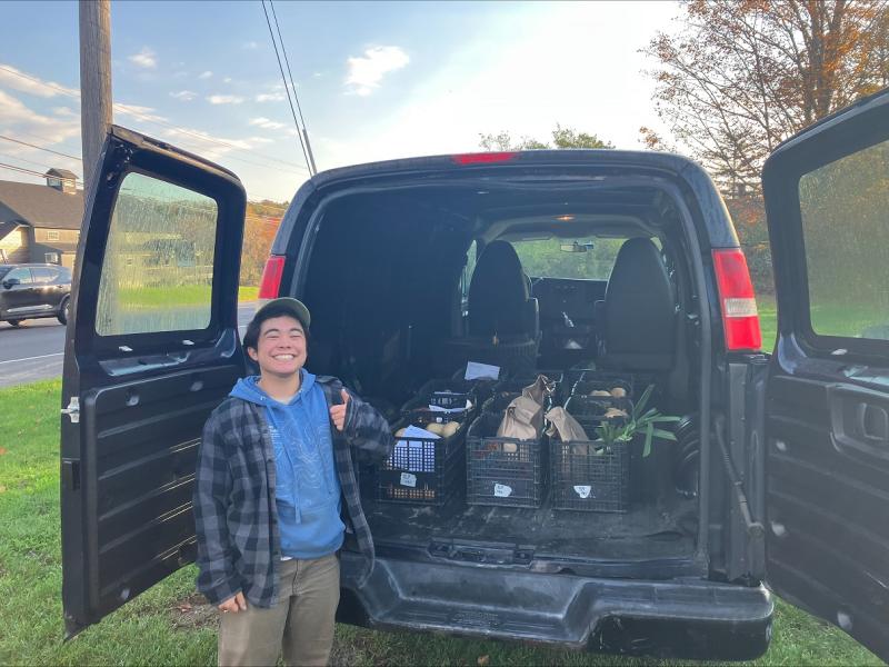 Matsu Hikida, Erickson Fields Program Assistant, loads the van with 12 heavy crates of produce for deliveries to four food pantries. (Photo courtesy MCHT)