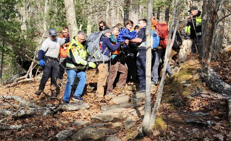 Camden Fire and Rescue, Coastal Mountains Search and Rescue volunteers, Camden police officers and a North East Mobile Health Services EMS crew member carefully descended Mt. Battie with an injured hiker, moving the basket hand-over-hand at a steady, methodical rate down to a waiting ambulance. (Photo courtesy Camden Fire and Rescue)