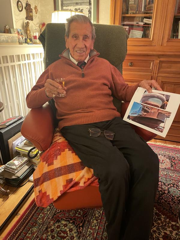 Charles Norman Shay holding pictures of the ferry that will carry his name as well as some of his relatives who travel on this vessel. (Photo courtesy Maine Department of Transportation)