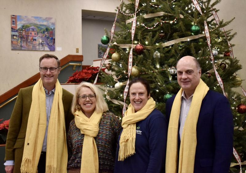 Patrisha McLean and Nicole Gogan of Finding Our Voices are flanked by Camden National Bank President Greg Dufour on the right and his successor Simon Griffiths on the left. “Mr. Dufour and Mr. Griffiths were good sports about wearing our trademark yellow for the photo,” said McLean, in a news release. Yellow is the nonprofit’s color because, according to McLean, “we are survivors of domestic abuse who have managed to cross over into the light of freedom and safety and are now shining a light for the benefit of all in Maine.” (Photo by Viktorie Mathiau)