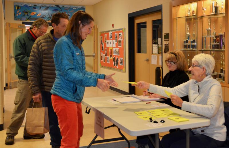 Lincolnville voters sign in at the door Dec. 11. (Photo by Lynda Clancy)