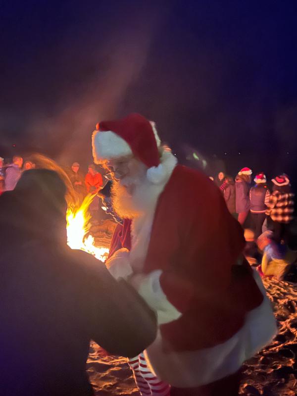 Santa came to warm himself at the fire. (Photo by Tracee O’Brien)