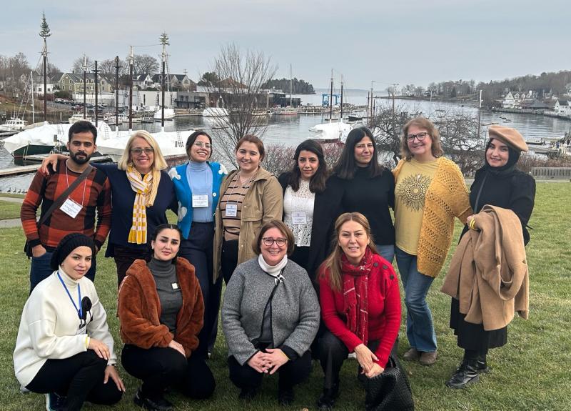 Iraqi domestic violence activists visited with Finding Our Voices in Camden on a State Department-sponsored tour of the United States. Finding Our Voices Founder/CEO Patrisha McLean is second from the left in the back. Finding Our Voices Operations Manager Mary Kamradt is in this same row second from the right. Allison Hodgkins, executive director of the World Affairs Council of Maine, is in the front with the grey sweater. (Photo by Matt LaJoie of the Camden Public Library)