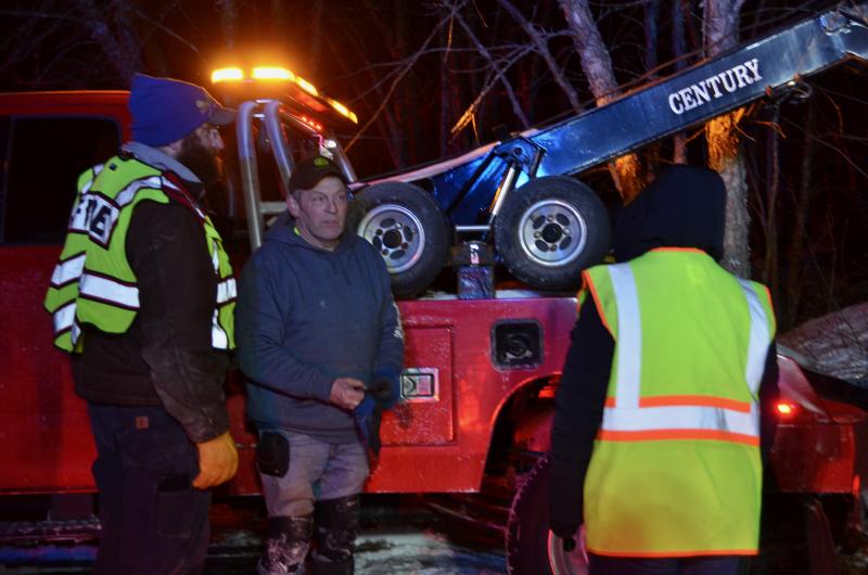 Rockport Lt. Chief Clay Tolman and Camden Exxon owner Steve Laite, after the Jeep is hauled up from the quarry’s edge. (Photo by Lynda Clancy)