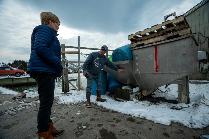 Port Clyde Fisherman’s Co-Op Manager Gerry Cushman, right, recalls how high the water was during the January storms. Port Clyde and Tenants Harbor were among the areas most damaged during the winter storms earlier this month.