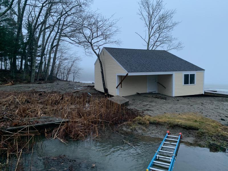 A boathouse on Camden Harbor was shoved askew by the ocean Jan 10, and buffeted again on the shore, Jan. 13.