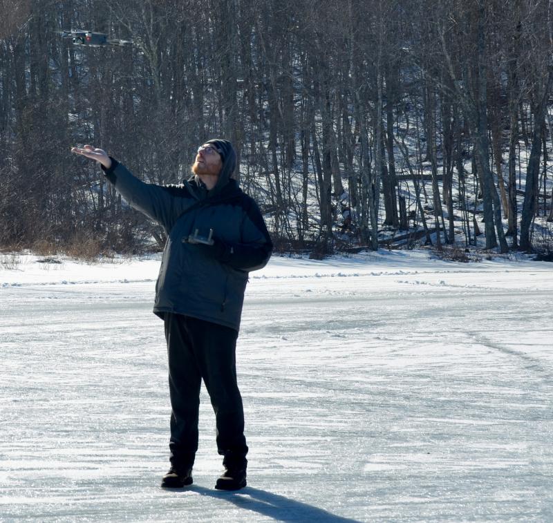 Photographer Isaac Remsen carefully brings his drone back down to earth.