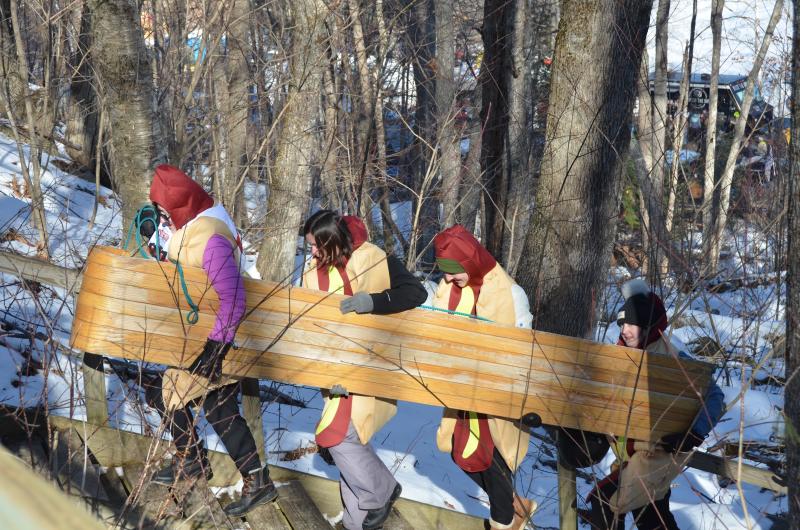 No matter how fit and trim the crew might be, the walk up the stairs to the top of the chute is always a test of team’s mettle. But then, the ride back down is a fury of adrenaline and an exciting blast across the icy pond.