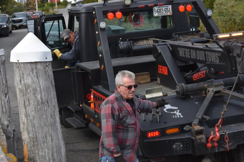 Larry Oakes uses a smaller wrecker from his fleet in October 2019 to pull a suburban from Tenants Harbor. (Photo by Sarah Thompson) c