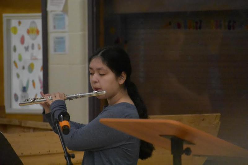 Alita Higley, 7th grade, performs a solo rendition of Star Spangled Banner prior to the start of the ceremony. (Photo by Sarah Thompson)