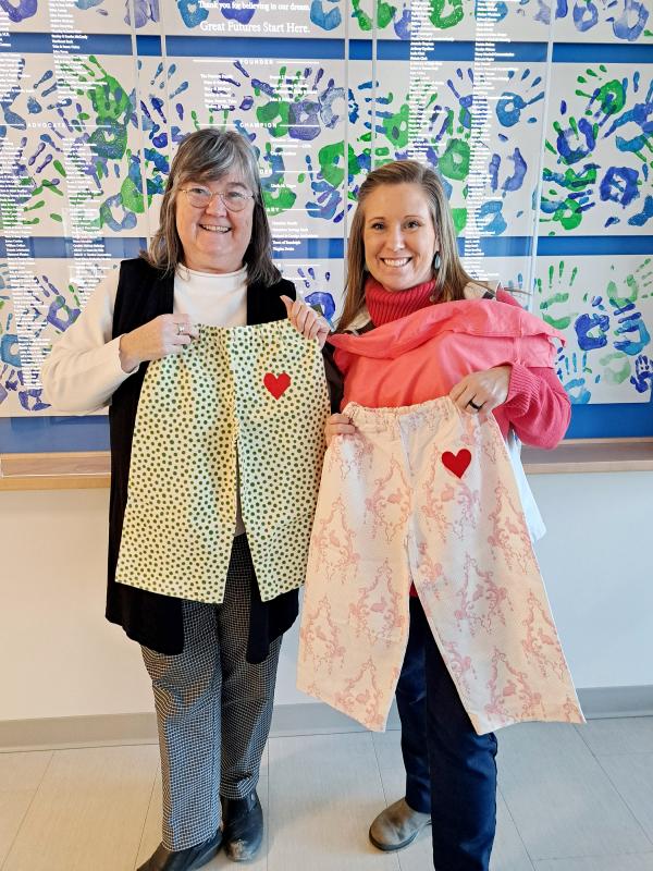 Extension Homemakers State Director Lisa Fishman delivers pajamas to Nicole Cooley, Development Director of the Boys and Girls Clubs of Kennebec County. (Photo courtesy University of Maine Cooperative Extension)