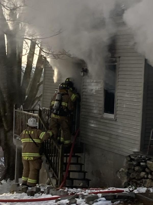 Firefighters push their way into the burning kitchen. (Photo by Kevin Curry)