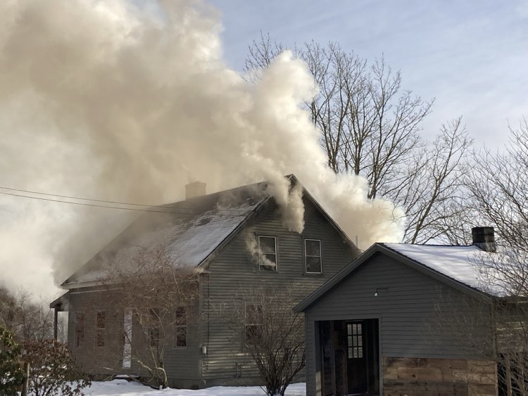 Smoke fills a house at 1406 Eastern Road, in Warren, Sunday evening, March 24, 2024. (Photo by Kevin Curry)
