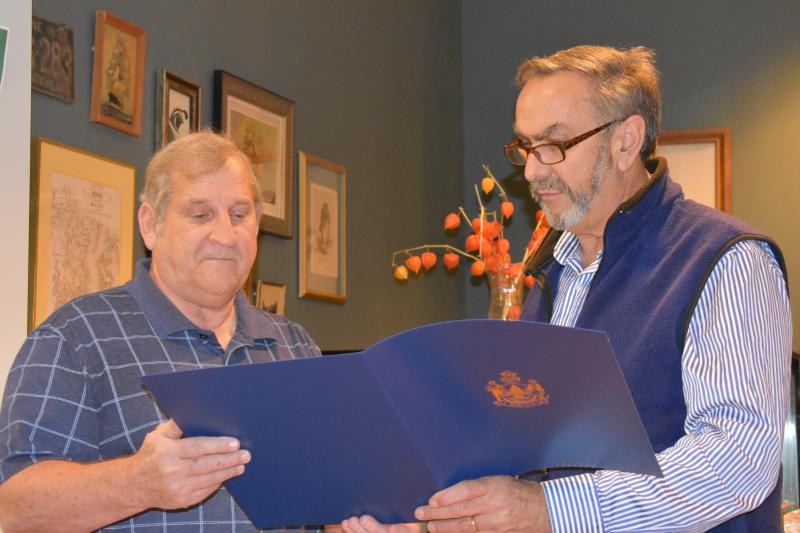 Retiring Knox County Regional Airport director Jeffrey Northgraves (left), looks on as State Legislator Representative Dave Miramant reads aloud from Northgraves’ certificate of recognition in 2019 when Knox County legislators surprise airport Manager Jeff Northgraves with state recognition. (Photo by Sarah Thompson)
