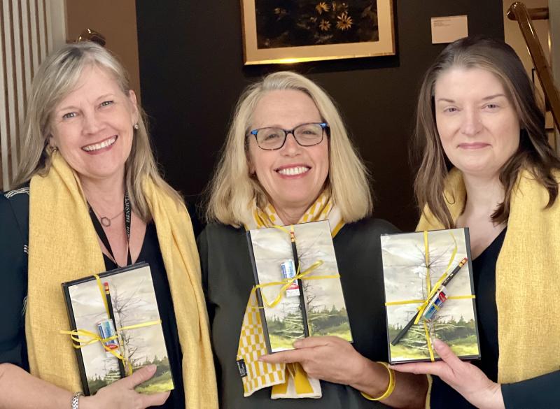 From left to right, each holding one of the 100 Andrew Wyeth journals donated by the Farnsworth Museum to domestic abuse survivors: Katherine Karlik, the museum’s Manager of Community Engagement and Volunteers; Finding Our Voices CEO and founder Patrisha McLean; and Gwendolyn Loomis Smith, the museum’s Phyllis Wyeth Director of Learning and Engagement. (Photo supplied by Finding Our Voices)