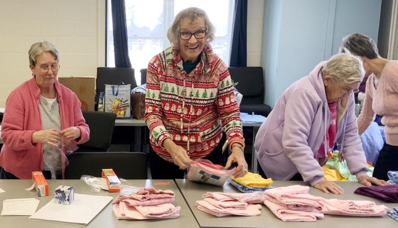 Betty Robshaw (Hancock County), Rita Fortin (Somerset County), and Mary Soper (Hancock County) package pajamas for delivery to local children. (Photo courtesy University of Maine Cooperative Extension)