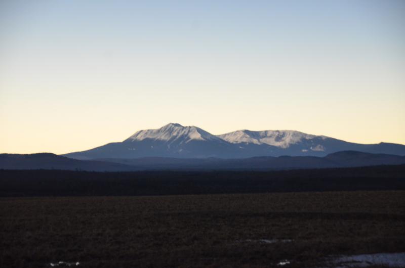 Katahdin’s snowy flanks lightened as the moon moved away from the sun, allowing its rightful place in the day. (Photo by Lynda Clancy)