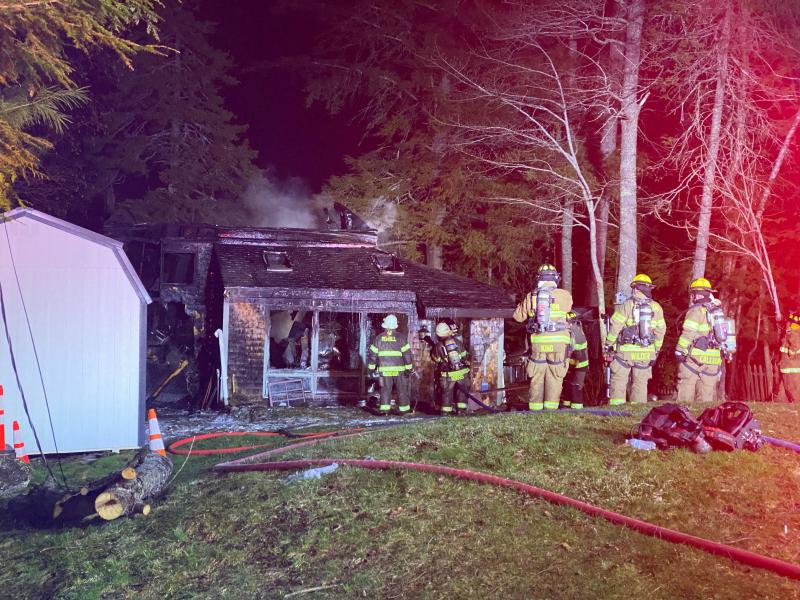 Firefighters look for any remaining flames after battling a house fire at 59 Levenseller Pond Road, in Searsmont. (Photo by Bradlee Watts)
