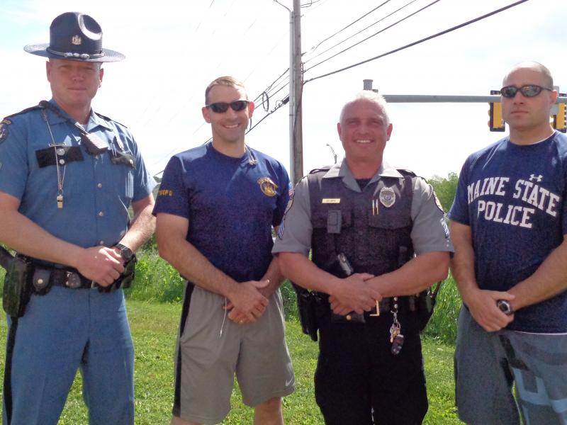 Police Chief Timothy Hoppe (in uniform and vest) stands with Jeremy Wesbrock, Patrick Hood, and Jason Andrews at a Law Enforcement Torch Run for Special Olympics in 2016. (Photo by Sarah Thompson)
